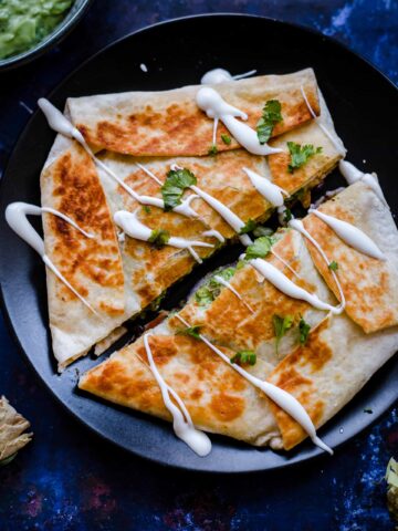 Crunch Wrap on plate, drizzled with sour cream