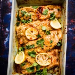 Salmon in a baking dish with lemons