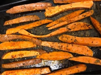Sweet Potato fries with spices on tray 