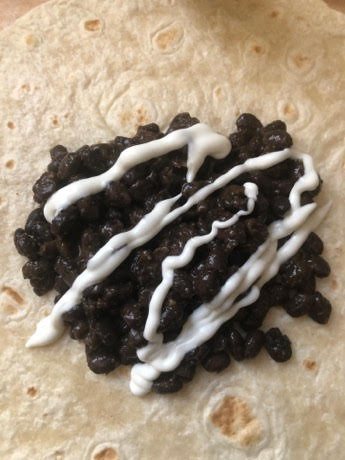 Black beans topped with sour cream
