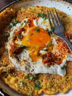 Besan Chilla with fried egg on top