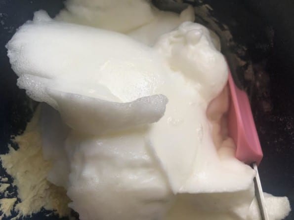 Egg whites being folded in with spatula