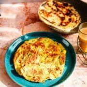 Masala Omelette on table with paratha and tea