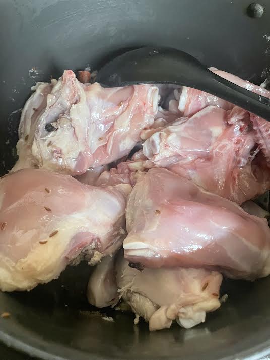 Chicken added to pot