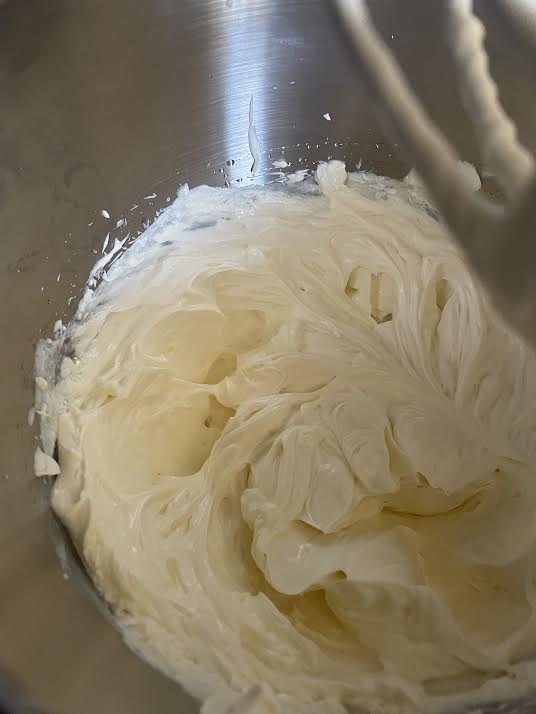 Beaten cream cheese in stand mixer bowl