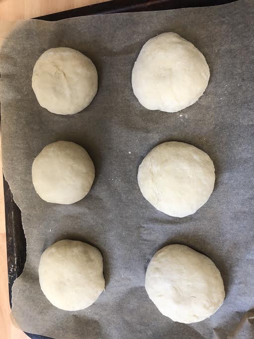 Buns shaped and on a lined tray