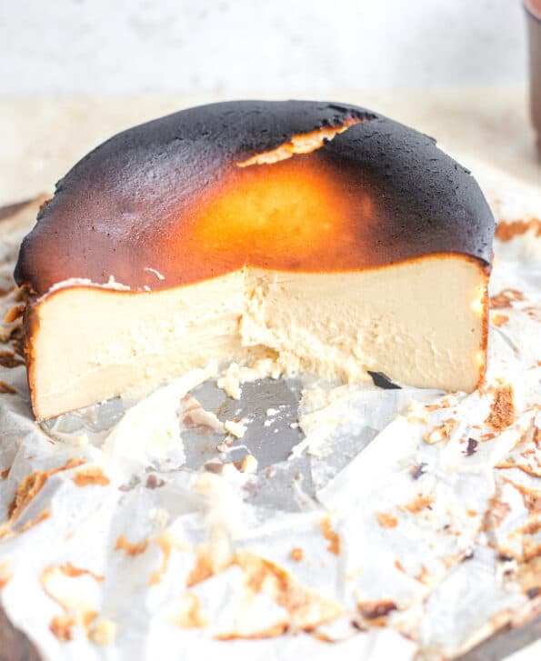 Basque cheesecake cut in half to show creamy interior