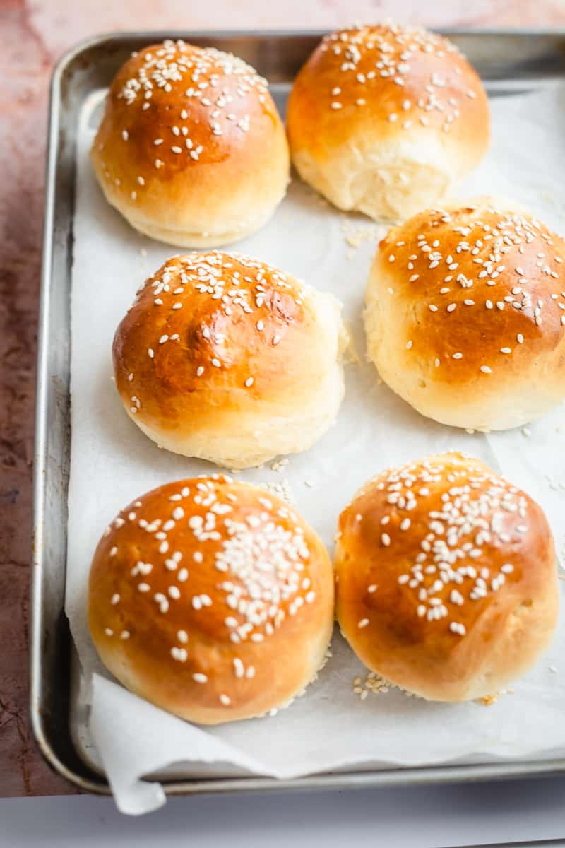 6 Burger buns with sesame seeds on a tray 