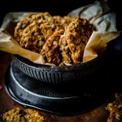 Anzac biscuits in a bowl with greaseproof paper