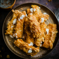 Halloumi Fries in plate with sour cream topping