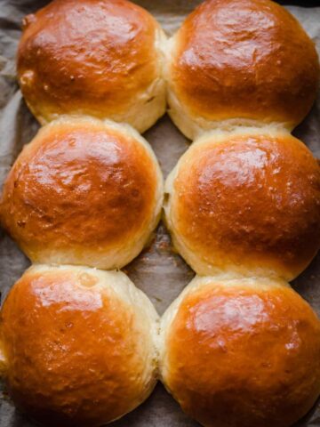 Baked buns on lined tray