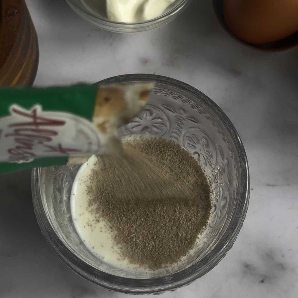 Yeast being added to milk in cup