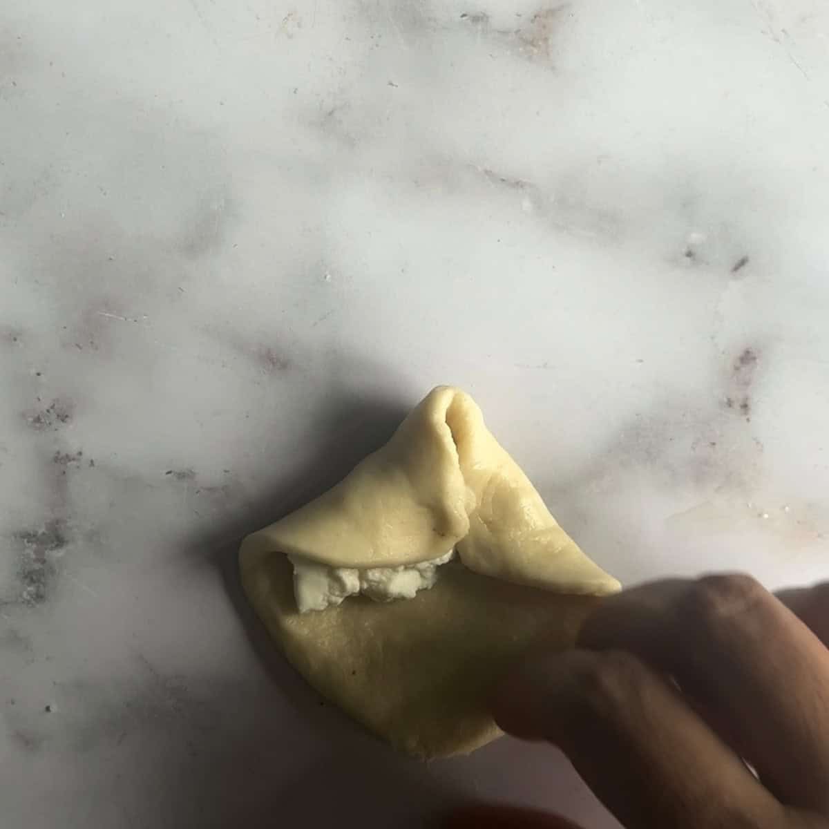 Sides of bun on top of cream cheese