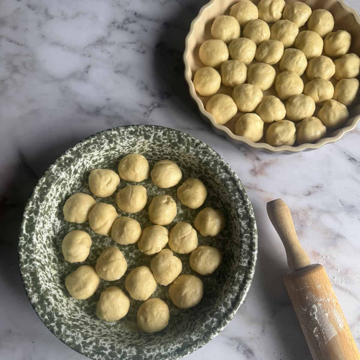 Completed buns spread between 2 dishes