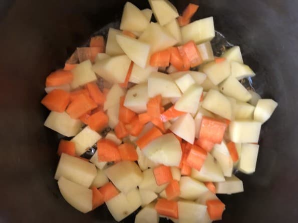 Potatoes and carrots in pot