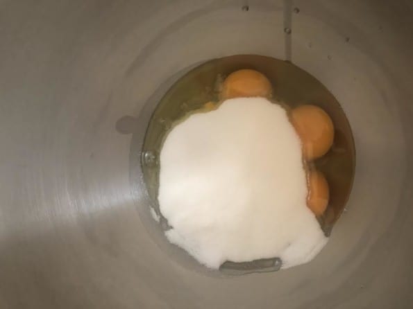 Sugar and eggs in bowl of stand mixer