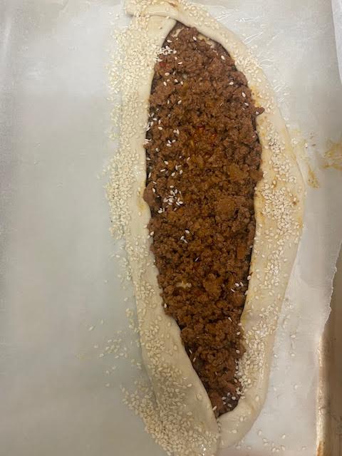 Pide added to tray with Sesame Seeds on edges