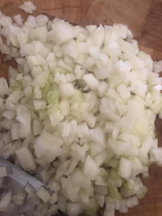 Onions diced on a chopping board