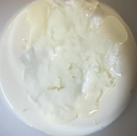 Yoghurt, oil and lemon in bowl