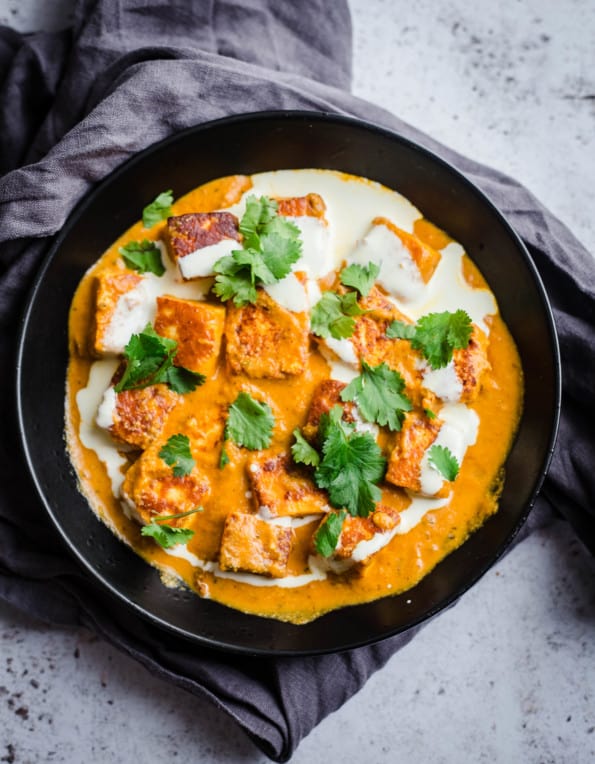 Shahi Paneer in black bowl with cream and coriander 