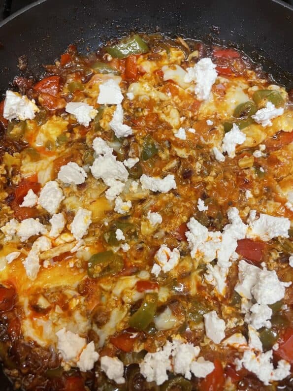 Feta added to Eggs in pan