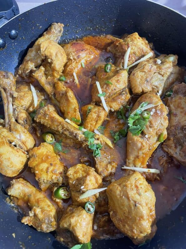 Karahi garnished with Ginger, Coriander and Green Chillies