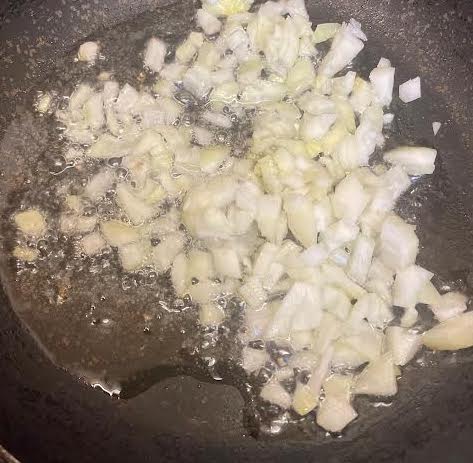 Onions in oil in pan