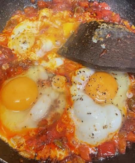 Eggs being scrambled in pan