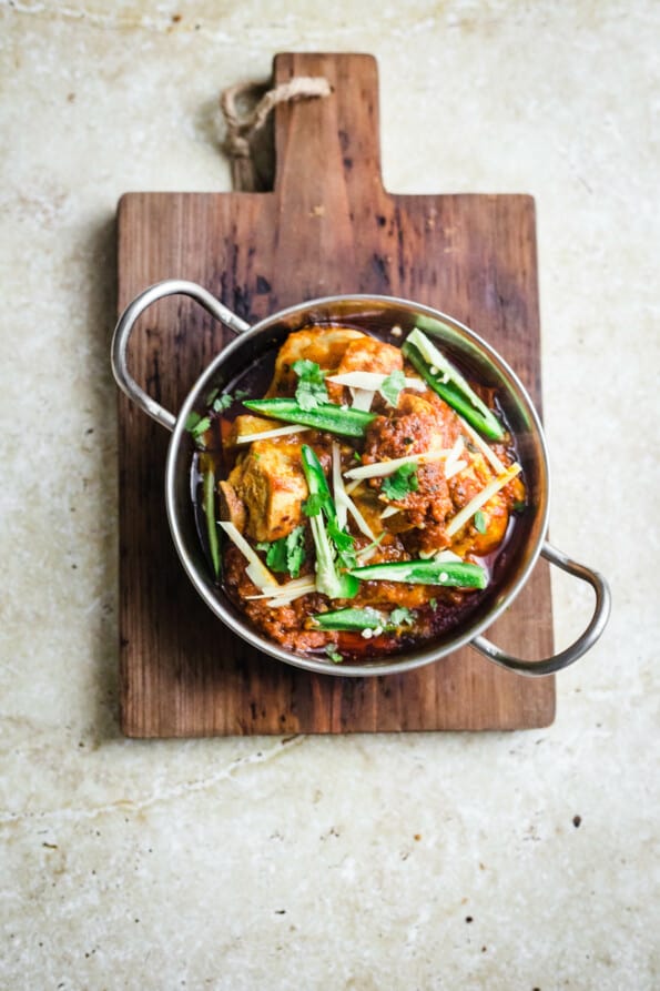 Karahi Chicken in a small wok on a wooden board