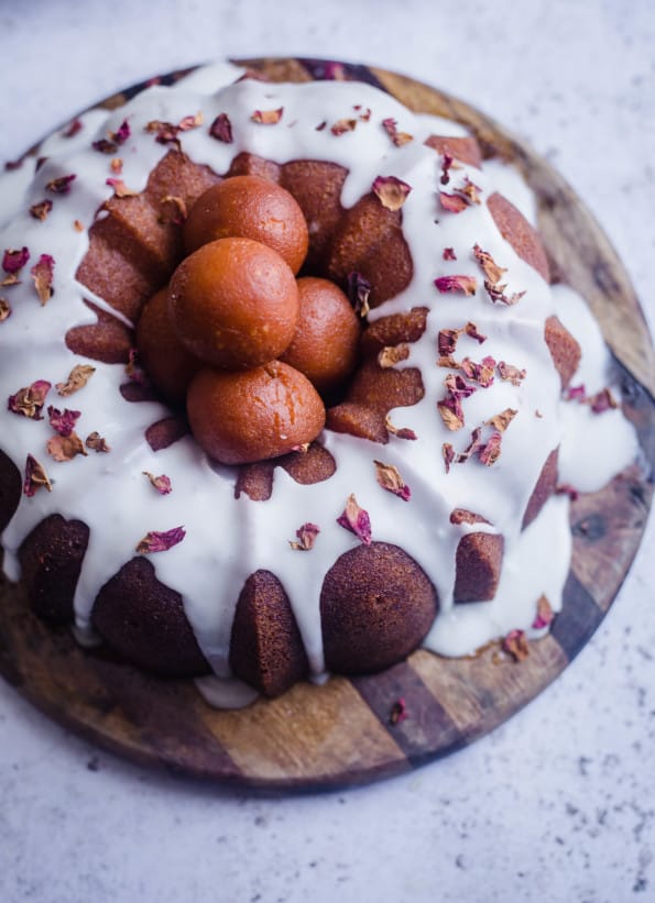 Gulab Jamun Cake on a board with rose petals for decoration