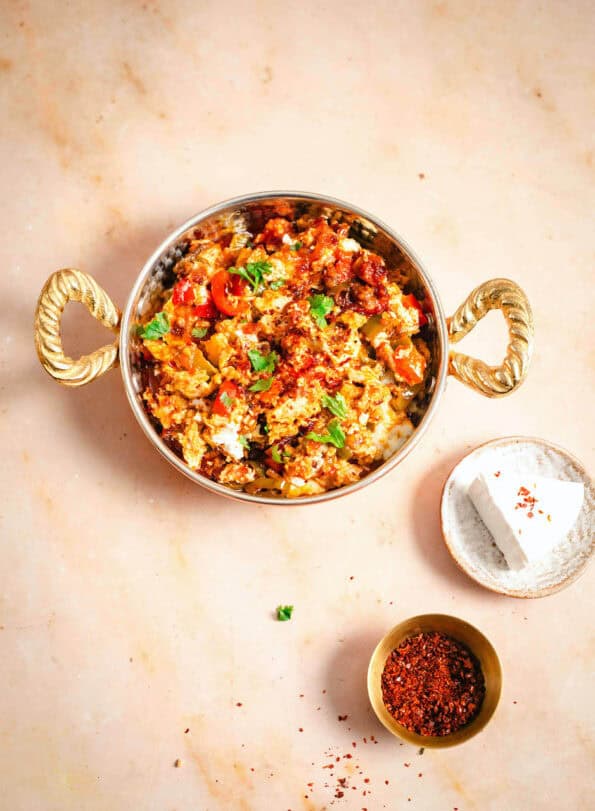 Menemen in dish with cheese and chilli to side