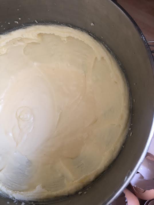 Smooth batter with egg shells next to bowl