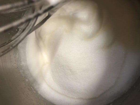 Sugar and whites being whisked in bowl