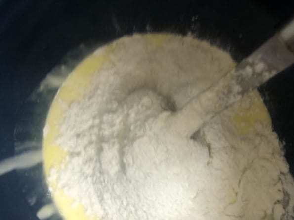 Flour and salt added to mixture in bowl