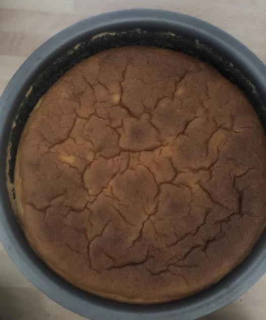 Cheesecake in tin after coming out of oven