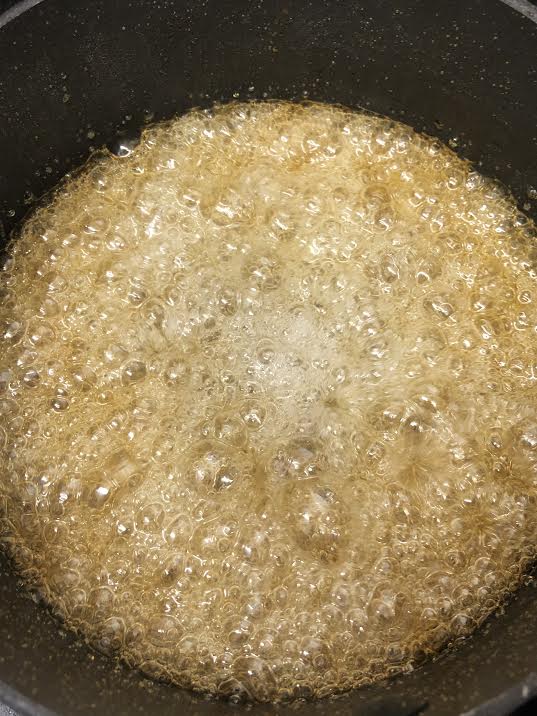 Golden sugar and water in pan