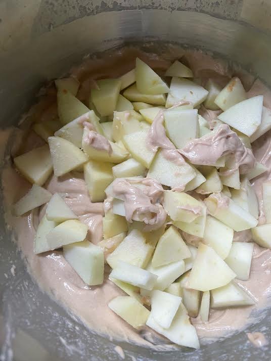 Apples added to batter in bowl