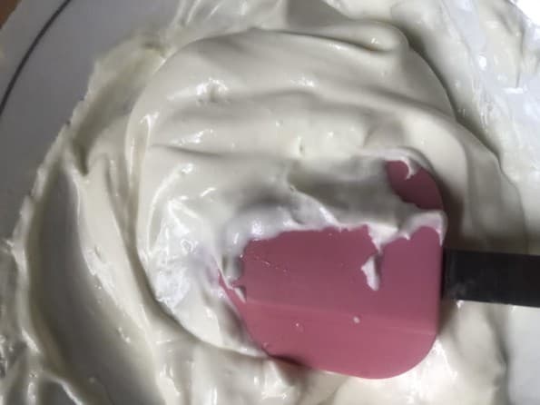 Melted cream cheese with spatula stirring
