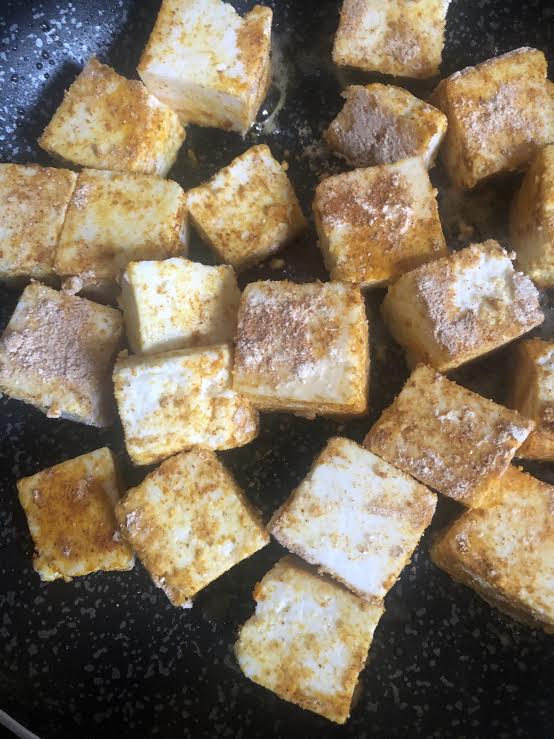 Masala cubes in oil in pan