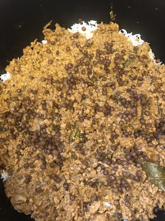 Another layer of keema and dal added on top of rice layer