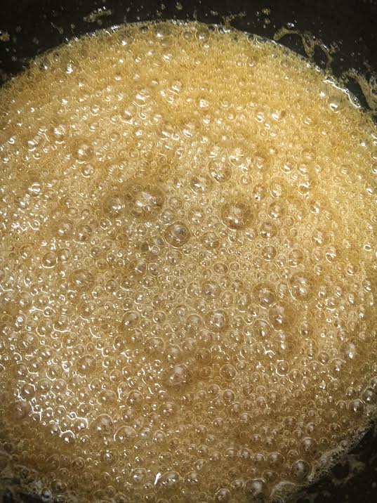 Deep golden sugar and water foaming in pan