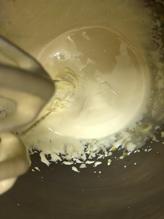Egg yolks and sugar being whisked in a bowl