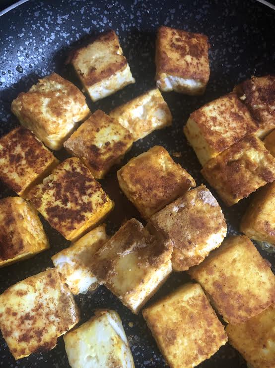 Golden brown Paneer cubes in pan