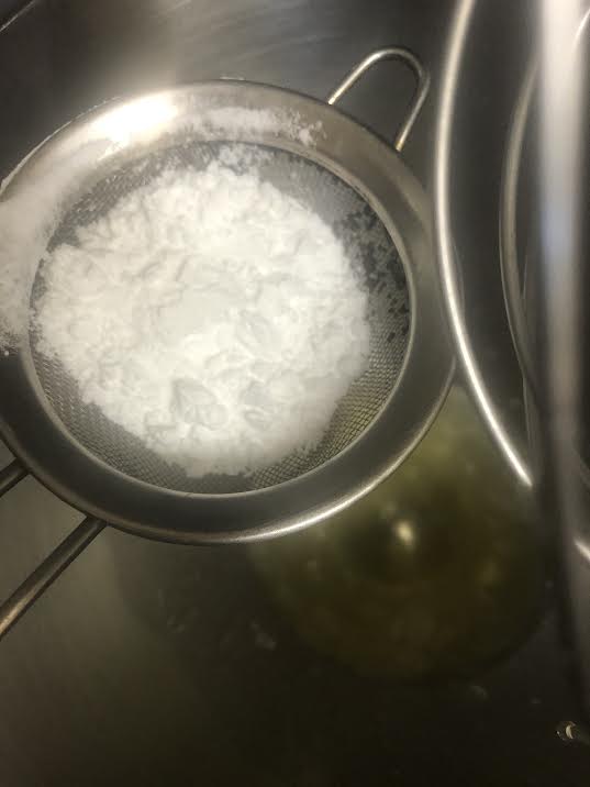Icing sugar being sieved into egg whites