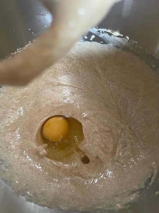 Egg added to batter in bowl of stand mixer