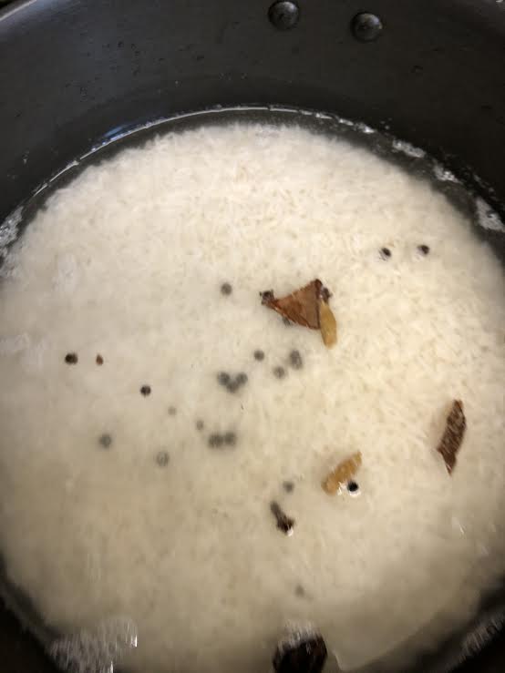 Rice in pot with whole garam masala spices