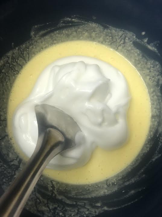 Egg whites being folded into bowl