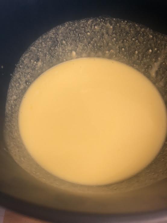 Eggs whisked into mixture in bowl