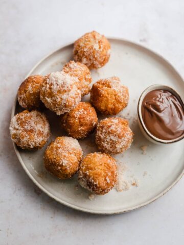 Donuts without yeast on a plate with chocolate sauce in small bowl