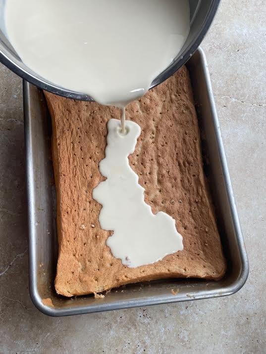 Milk being poured into cake